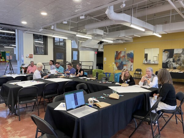 People around a table in a workshop setting